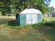 Green metal storage shed in backyard at 507 Barwick St, Wildwood, FL 34785