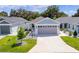 One-story house with gray garage door and small front yard at 5238 Dalessandro Rd, The Villages, FL 32163