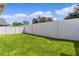 Spacious backyard with grassy area and privacy wall at 5238 Dalessandro Rd, The Villages, FL 32163