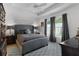 Spacious bedroom with a gray bed and a ceiling fan at 5238 Dalessandro Rd, The Villages, FL 32163