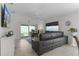 Spacious living room with a large sectional sofa and sliding glass doors leading to the backyard at 5238 Dalessandro Rd, The Villages, FL 32163