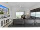 Living room featuring a sectional sofa, large TV, and access to backyard at 5238 Dalessandro Rd, The Villages, FL 32163