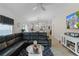 Open living room with sectional sofa and view of the kitchen at 5238 Dalessandro Rd, The Villages, FL 32163