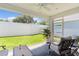 Cozy screened patio furnished with seating and a ceiling fan at 5238 Dalessandro Rd, The Villages, FL 32163