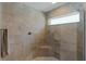 Large walk-in shower with neutral tile and built-in seat at 5238 Dalessandro Rd, The Villages, FL 32163