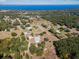 Aerial view showing home, expansive land, and lake at 7620 Arrow Ln, Yalaha, FL 34797