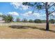 Spacious backyard with white fence and mature trees at 7620 Arrow Ln, Yalaha, FL 34797