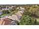 Aerial view of homes in a lush neighborhood near golf course at 877 Winifred Way, The Villages, FL 32162