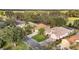 Aerial view of house and neighborhood with golf course at 877 Winifred Way, The Villages, FL 32162