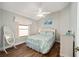 Bright bedroom featuring wood flooring and a ceiling fan at 877 Winifred Way, The Villages, FL 32162