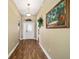 Light-filled entryway with wood floors leading to the living areas at 877 Winifred Way, The Villages, FL 32162