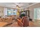 Relaxing living room featuring a sectional sofa and leather armchair at 929 Magnolia Blossom Ct, Apopka, FL 32712