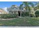 Two story house exterior, front yard, and landscaping at 929 Magnolia Blossom Ct, Apopka, FL 32712