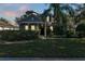 Two-story house with front porch, landscaping, and a well-maintained lawn at 929 Magnolia Blossom Ct, Apopka, FL 32712