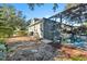 Relaxing pool area with screened enclosure and stone pathway at 929 Magnolia Blossom Ct, Apopka, FL 32712