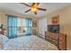 Cozy bedroom with a comfortable bed, TV, and ample closet space at 929 Magnolia Blossom Ct, Apopka, FL 32712