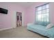 Bright bedroom with a twin bed, closet, and window at 1148 Calloway Cir, Clermont, FL 34711