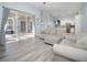 Living room with sliding glass doors to patio and neutral colored couch at 1148 Calloway Cir, Clermont, FL 34711