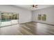 Living room with hardwood floors and sliding doors to the pool at 1324 Falconcrest Blvd, Apopka, FL 32712