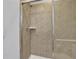 Shower with glass enclosure and neutral tile at 1603 Lima Ave, Kissimmee, FL 34747