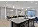 Open kitchen features granite countertops, a large island, and views into dining area at 1603 Lima Ave, Kissimmee, FL 34747