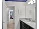 Bathroom with granite countertop, dark vanity, and a view into a bedroom at 1603 Lima Ave, Kissimmee, FL 34747