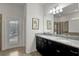 Bathroom with double vanity and view of the pool at 1603 Lima Ave, Kissimmee, FL 34747