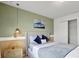 Bedroom with a queen bed, window blinds, and green walls at 1603 Lima Ave, Kissimmee, FL 34747