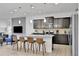 Modern kitchen with granite countertops, stainless steel appliances, and island with seating at 1603 Lima Ave, Kissimmee, FL 34747