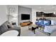 Modern living room with gray couches and a large flat-screen TV at 1603 Lima Ave, Kissimmee, FL 34747