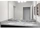 Double vanity bathroom with granite countertops and large mirror at 1603 Lima Ave, Kissimmee, FL 34747