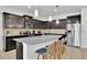 Modern kitchen with dark cabinets, granite countertops, and stainless steel appliances at 1603 Lima Ave, Kissimmee, FL 34747