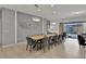 Spacious dining area with a large wooden table, gray chairs, and modern lighting at 1603 Lima Ave, Kissimmee, FL 34747