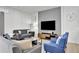 Comfortable living area featuring a gray sectional sofa and stylish decor at 1603 Lima Ave, Kissimmee, FL 34747