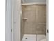 Shower with glass enclosure and neutral tile at 1603 Lima Ave, Kissimmee, FL 34747