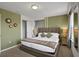 King-size bed in a green-walled bedroom at 1603 Lima Ave, Kissimmee, FL 34747