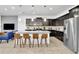 Sleek kitchen with dark wood cabinets, granite island, and stainless steel fridge at 1603 Lima Ave, Kissimmee, FL 34747
