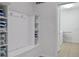 Laundry room with washer, dryer, shelving, and built-in bench at 1603 Lima Ave, Kissimmee, FL 34747