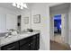 Bathroom with granite countertop, dark vanity, and a view of a bedroom at 1603 Lima Ave, Kissimmee, FL 34747