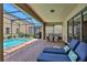 Covered patio with pool, spa, and lounge chairs at 1603 Lima Ave, Kissimmee, FL 34747