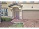 Inviting exterior with a two-car garage and a brick walkway at 1603 Lima Ave, Kissimmee, FL 34747