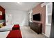 Bedroom with two twin beds, dresser, and red accent wall at 1603 Lima Ave, Kissimmee, FL 34747