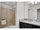 Bathroom with granite countertop, dark vanity, and a shower at 1603 Lima Ave, Kissimmee, FL 34747