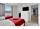Cozy twin bedroom with red accents and a view at 1603 Lima Ave, Kissimmee, FL 34747