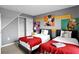 Twin bedroom with Mickey Mouse decor and red blankets at 1603 Lima Ave, Kissimmee, FL 34747