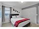 Bedroom with a queen bed, closet, and geometric wall decor at 1603 Lima Ave, Kissimmee, FL 34747