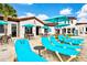 Relaxing patio area with turquoise lounge chairs and bar at 1603 Lima Ave, Kissimmee, FL 34747
