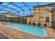 Screened-in pool and spa with brick pavers at 1603 Lima Ave, Kissimmee, FL 34747