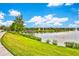 Walking path alongside lake, lush grass, and fountain at 1603 Lima Ave, Kissimmee, FL 34747