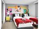 Twin bedroom with Mickey Mouse themed decor and red bedding at 1603 Lima Ave, Kissimmee, FL 34747